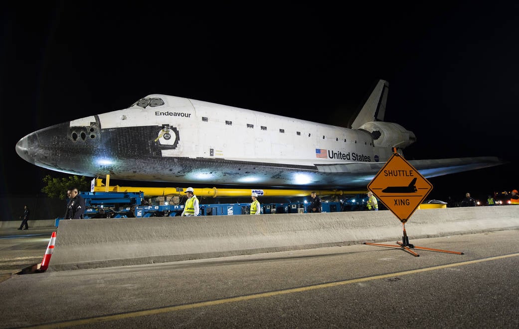 Space shuttle Endeavour weighed roughly 170,000 pounds, yet its final 12-mile journey through Los Angeles took 68 hours at no more than 2 mph—crews repeatedly stopped to trim trees and squeeze its 78-foot wingspan past obstacles with inches to spare. - Space Daily